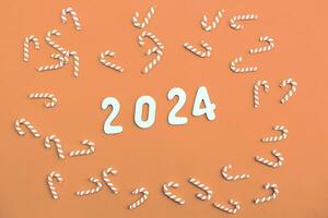 wooden Numbers 2024 on Peach Fuzz background .Festive concept photo