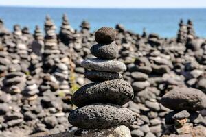stacks of rocks in front of the ocean photo