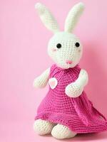 AI generated Knitted rabbit in pink dress. st. valentine's day decor. knitted toy, amigurumi. valentines day greeting card ai generated photo