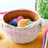 AI generated Multi-colored tangles of yarn in a wicker basket on the table. tea in a beautiful white cup. japanese style wabi sabi. home comfort, handicraft. ai generated photo
