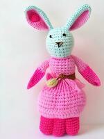 AI generated Knitted rabbit in pink dress. st. valentine's day decor. knitted toy, amigurumi. valentines day greeting card ai generated photo