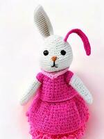 AI generated Knitted rabbit in pink dress. st. valentine's day decor. knitted toy, amigurumi. valentines day greeting card ai generated photo