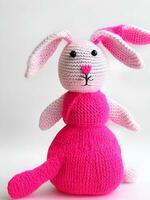 AI generated Knitted rabbit in pink dress. st. valentine's day decor. knitted toy, amigurumi. valentines day greeting card ai generated photo