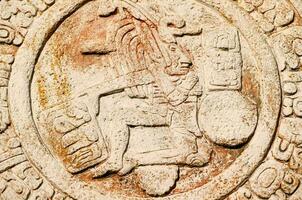 ancient mexican art, a stone relief depicting a man with a shield photo