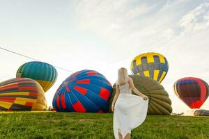 Amazing view with woman and air balloon. Artistic picture. Beauty world. The feeling of complete freedom photo