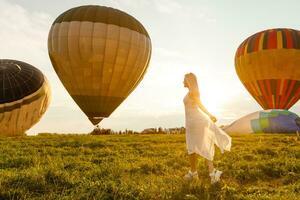 Amazing view with woman and air balloon. Artistic picture. Beauty world. The feeling of complete freedom photo