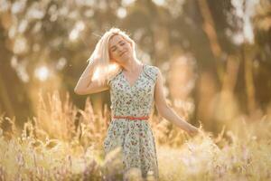 Bright Portrait of Happy Woman at Summer Field photo