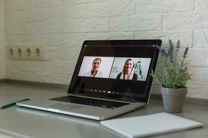 Business Person Videoconferencing With Colleagues On Laptop photo