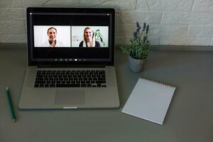 Business Person Videoconferencing With Colleagues On Laptop photo