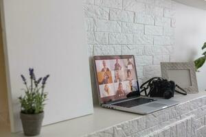 Business Person Videoconferencing With Colleagues On Laptop photo