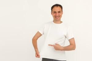 man shows a stain on his white t-shirt photo