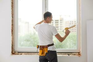 Caulking a new window frame photo