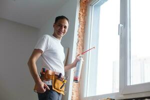 Caulking a new window frame photo