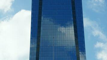 The skyscraper view with the reflections on its glass windows in the sunny day photo