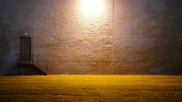 The factory wall view with the light on at night photo