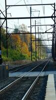 The railroad view with the parallel iron tracks and platform as background photo