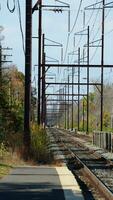 The railroad view with the parallel iron tracks and platform as background photo