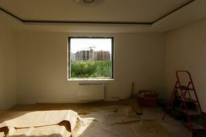 Empty frame on a wide panoramic window. Gorgeous view from the window of an apartment in a multi-storey building. Roofs of houses and trees from a height. Beautiful view through the window. Frame for photo