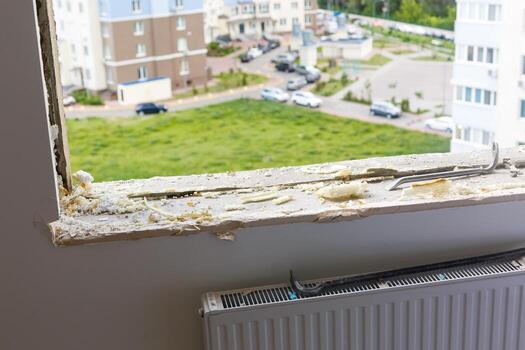 Empty frame on a wide panoramic window. Gorgeous view from the window of an apartment in a multi-storey building. Roofs of houses and trees from a height. Beautiful view through the window. Frame for photo