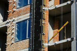 Thermal insulation of a house wall on a building site photo