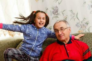 grandfather spends time with grandchildren in the living room photo