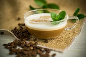 Cup of coffee latte with heart shape and coffee beans photo