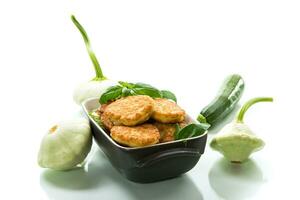 fried vegetable pancakes from squash and zucchini with herbs photo