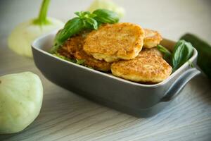 fried vegetable pancakes from squash and zucchini with herbs photo