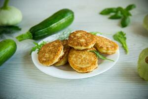 fried vegetable pancakes from squash and zucchini with herbs photo