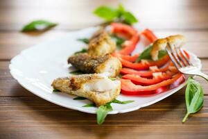 Pieces of fried hake fish in a plate with pepper photo