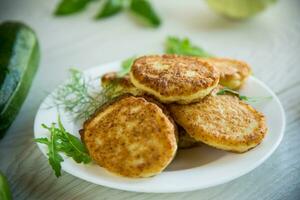 fried vegetable pancakes from squash and zucchini with herbs photo