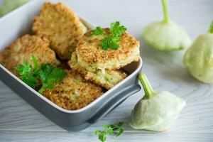 vegetable fried squash and zucchini cutlets in a ceramic form photo