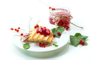 fried bread croutons for breakfast with redcurrant jam in a plate with berries photo