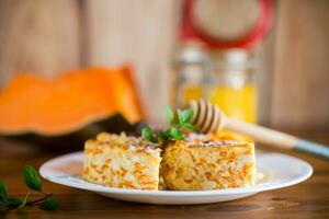 Cooked cottage cheese casserole with pieces of pumpkin inside. photo