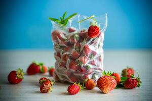 frozen fresh strawberries in a vacuum bag photo