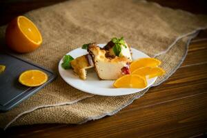 Sweet curd casserole with fruits in a plate photo