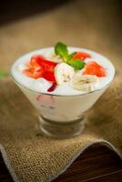 homemade sweet yogurt with bananas and pieces of fruit jelly photo