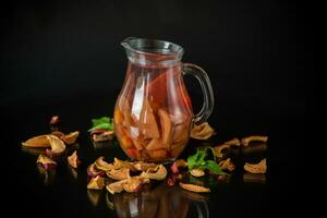 sweet cool compote boiled from various dried fruits, in a glass decanter photo