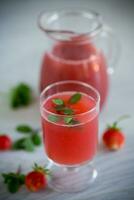 Cold summer strawberry kvass with mint in a glass photo