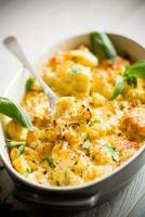 baked cauliflower with vegetables and cheese and scrambled eggs photo