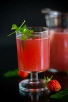 Cold summer strawberry kvass with mint in a glass photo