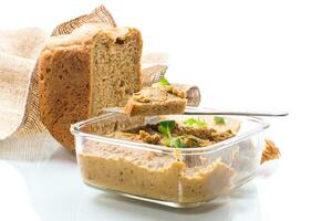 homemade meat pate with bread on a wooden table photo