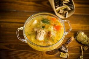 vegetarian vegetable soup with porcini mushrooms in a glass bowl photo