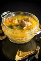 vegetarian vegetable soup with porcini mushrooms in a glass bowl photo