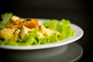 fried omelet with forest mushrooms chanterelles, on black background photo