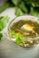 Spring soup from fresh sorrel with boiled eggs in a plate photo