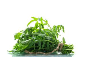 bunch of fresh organic green arugula on white background photo