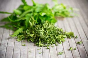 dried green organic arugula on wooden table photo