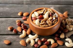 AI generated Healthy mix nuts on wooden background. Almonds, hazelnuts, cashews, peanuts, brazilian nuts. generative ai. photo