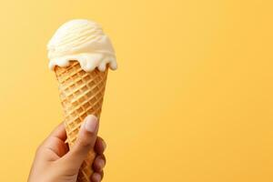 AI generated Hand holding vanilla milk ice cream cone on pastel background, a delightful summer treat photo